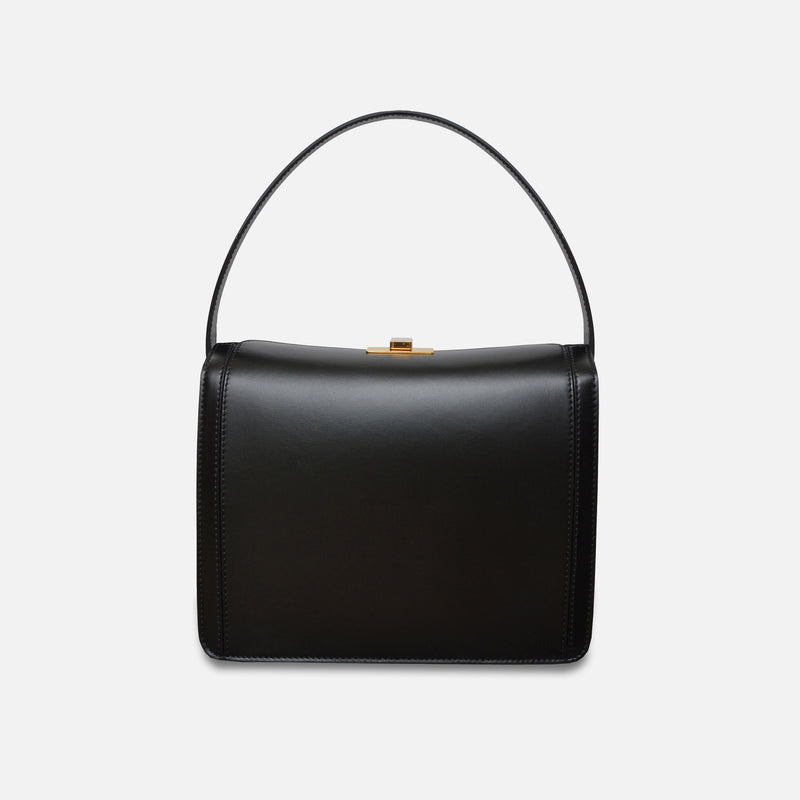 Classic Italian leather handbag with gold hardware.
Ccrossbody bag in a structured box design – Petit Palais by Susan Szatmáry.